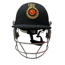 Load image into Gallery viewer, Black Ash custom IPL adjustable helmet, adorned with the logos of IPL teams like Kolkata Knight Riders and Mumbai Indians, featuring a high impact polypropylene shell, chrome finish steel grill with 8 micro adjustments, sweat-absorbent padding, adjustable to fit 52-58 cm, with nape dial adjuster and soft ear protection for optimal fit and protection.
