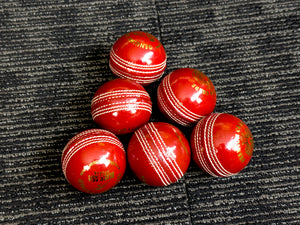 Pack of 6 red cricket balls from Black Ash Premium grade, featuring genuine leather with a 4-piece construction for excellent shape retention. These premium quality, machine-stitched balls are designed for 30 to 35 overs, meet MCC regulations, and each ball weighs 156 grams (5.5 oz).