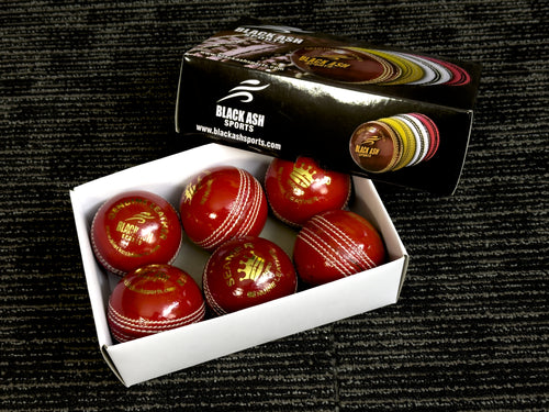 Pack of 6 red cricket balls, labeled 'Black Ash Seamer,' made from genuine leather with a 4-piece construction, offering excellent shape retention. These machine-stitched balls are suitable for practice T20 cricket, conform to MCC regulations, and each weighs 156 grams (5.5 ounces).