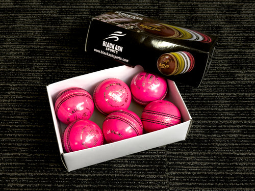 Pack of 6 pink cricket balls named 'Black Ash Cavalier,' crafted from premium quality, genuine Australian alum-tanned leather with a 4-piece construction for superior shape retention. These waterproof balls are suitable for 50 overs, conform to MCC regulations, machine-stitched, and each weighs 156 grams (5.5 ounces).