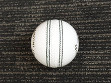 Load image into Gallery viewer, Pack of 6 white cricket balls from Black Ash Premium grade, made of genuine leather with 4-piece construction for excellent shape retention. These premium quality balls are machine-stitched, adhere to MCC regulations, and are ideal for 30 to 35 overs, each weighing 156 grams (5.5 ounces).