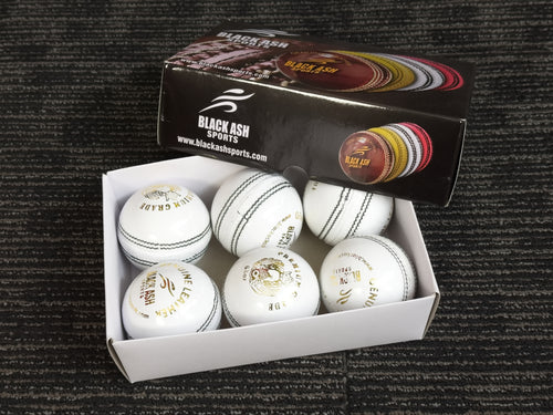Pack of 6 white cricket balls from Black Ash Premium grade, made of genuine leather with 4-piece construction for excellent shape retention. These premium quality balls are machine-stitched, adhere to MCC regulations, and are ideal for 30 to 35 overs, each weighing 156 grams (5.5 ounces).