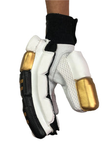 White/Gold Cricket Batting Gloves by Black Ash, with light-weight high-density foam, strong inserts in fingers for added protection, full leather palm and thumb, two-piece thumb for comfort, in white and gold.