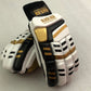 White/Gold Cricket Batting Gloves by Black Ash, with light-weight high-density foam, strong inserts in fingers for added protection, full leather palm and thumb, two-piece thumb for comfort, in white and gold.