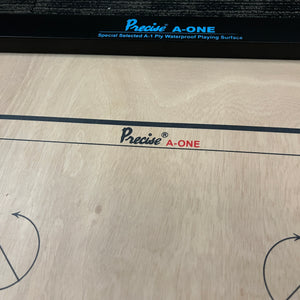 PRECISE Excel A-One carrom board with a 6mm thick special selected A-One waterproof ply, measuring 32x32 inches overall with a 29x29 inch playing area, 1.5-inch borders, and strong hand-knitted wool nets. Includes a striker and a set of coins, featuring plastic feet for elevation.