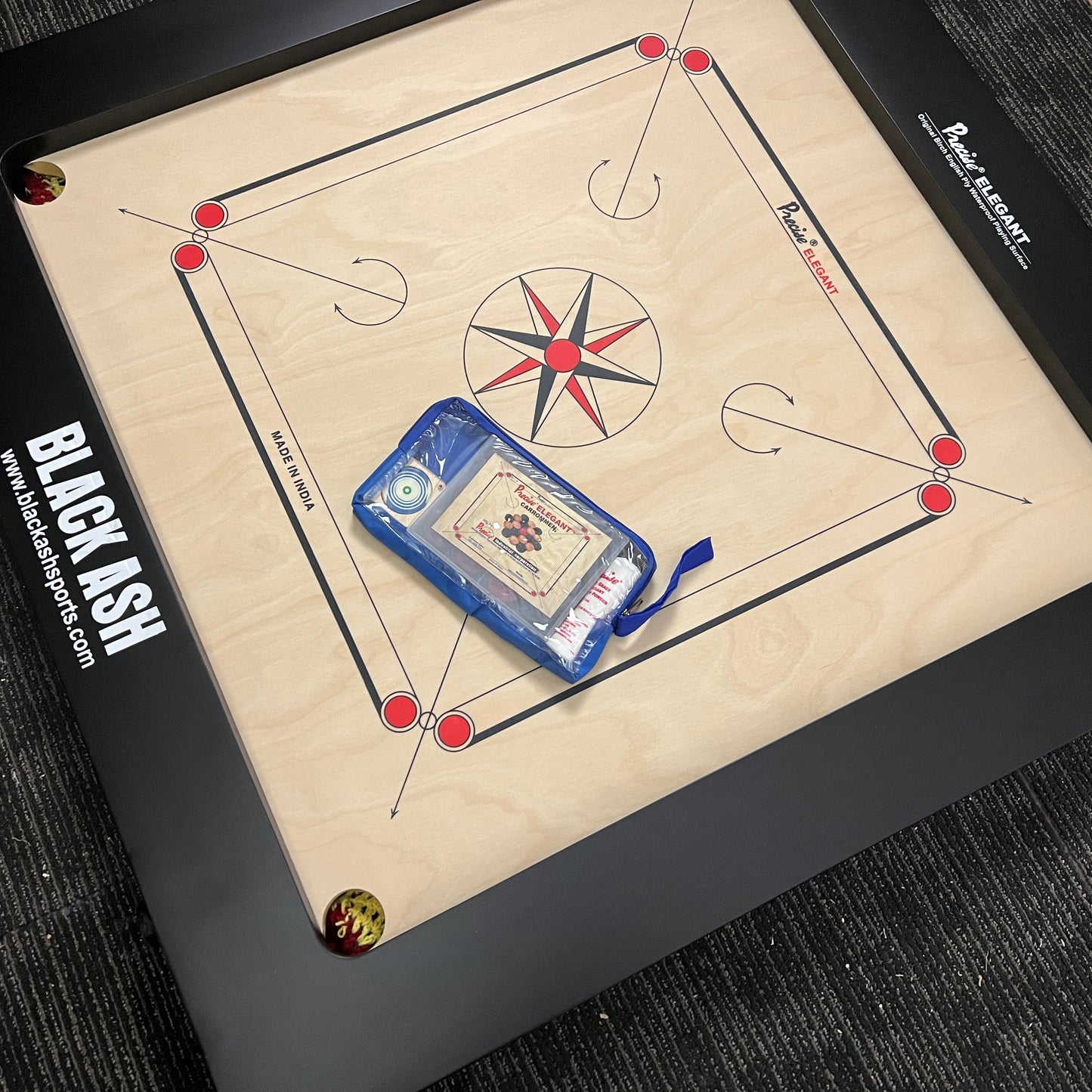 Precise Bulldog Elegant carrom board, 28mm thick English Birchwood ply, 37x37 inches overall size with a 29x29 inch playing area and 4-inch borders. Comes with a striker and a set of coins, known for its super satin smooth tournament playing surface.
