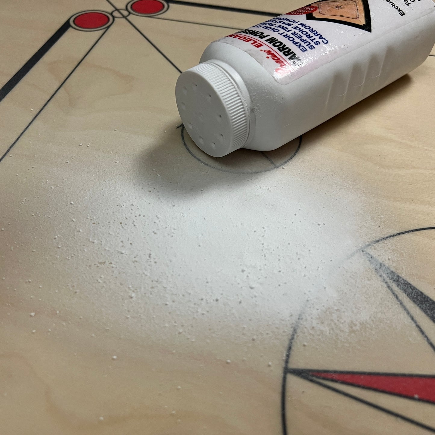 Specially formulated Precise Elegant carrom powder, 180g refillable bottle with a sifter cap, enhancing the playing surface of superior quality carrom boards, available exclusively at Black Ash Sports.