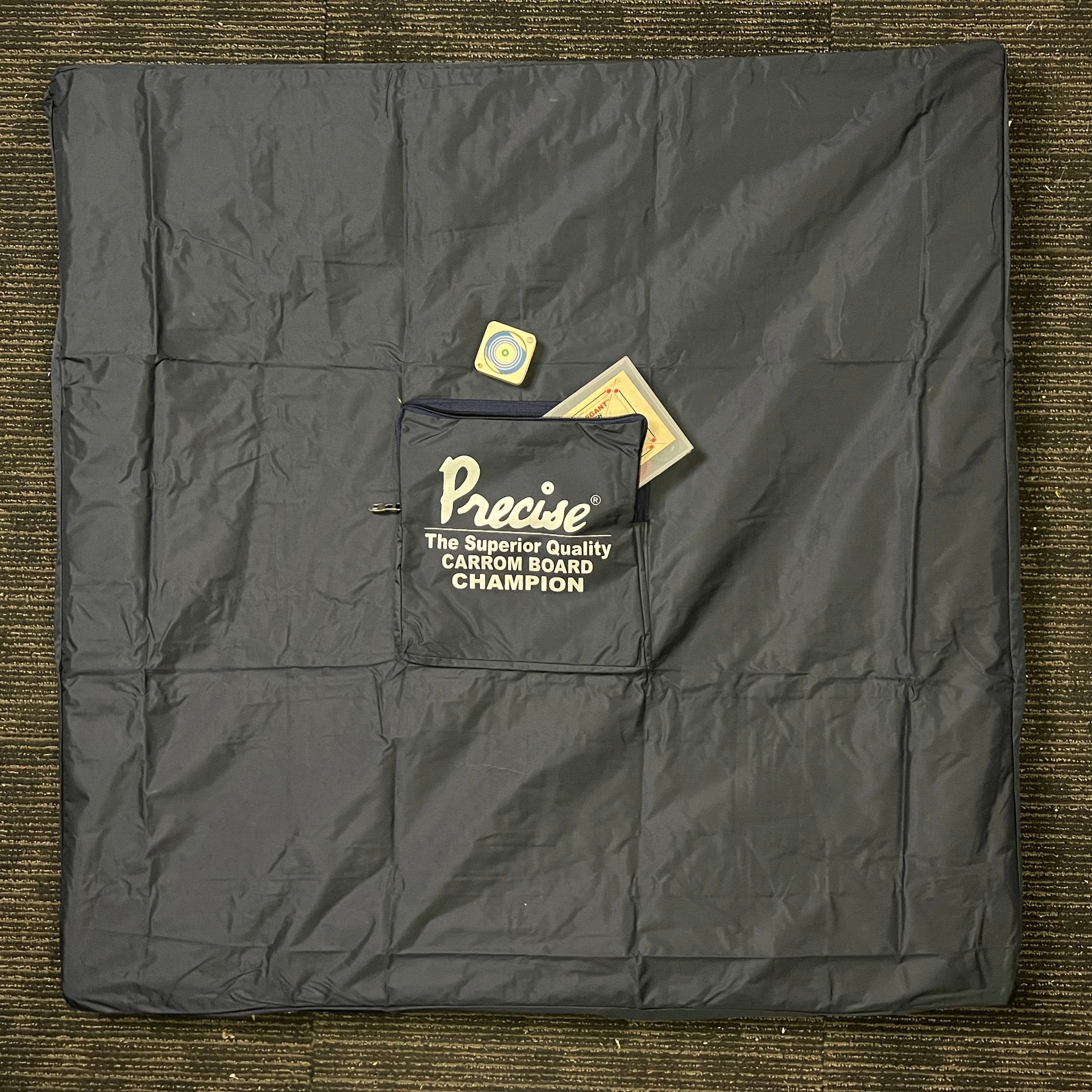 Protective cover made of heavy quality rexine for 35x35 inch carrom boards, with a storage pocket for carrommen and other accessories, available in 3 sizes.