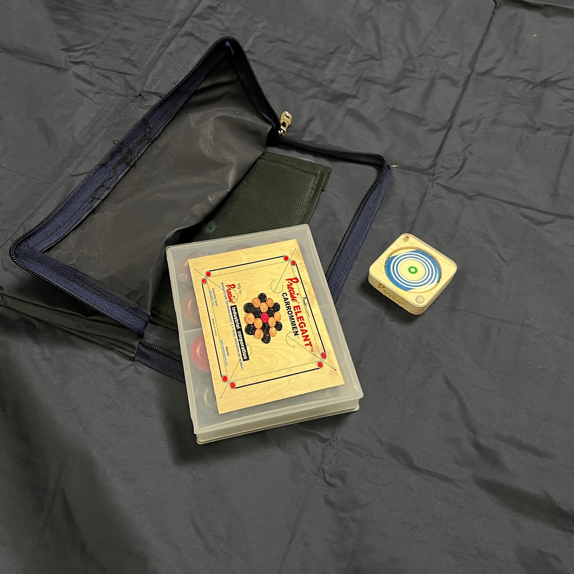 Protective cover made of heavy quality rexine for 35x35 inch carrom boards, with a storage pocket for carrommen and other accessories, available in 3 sizes.