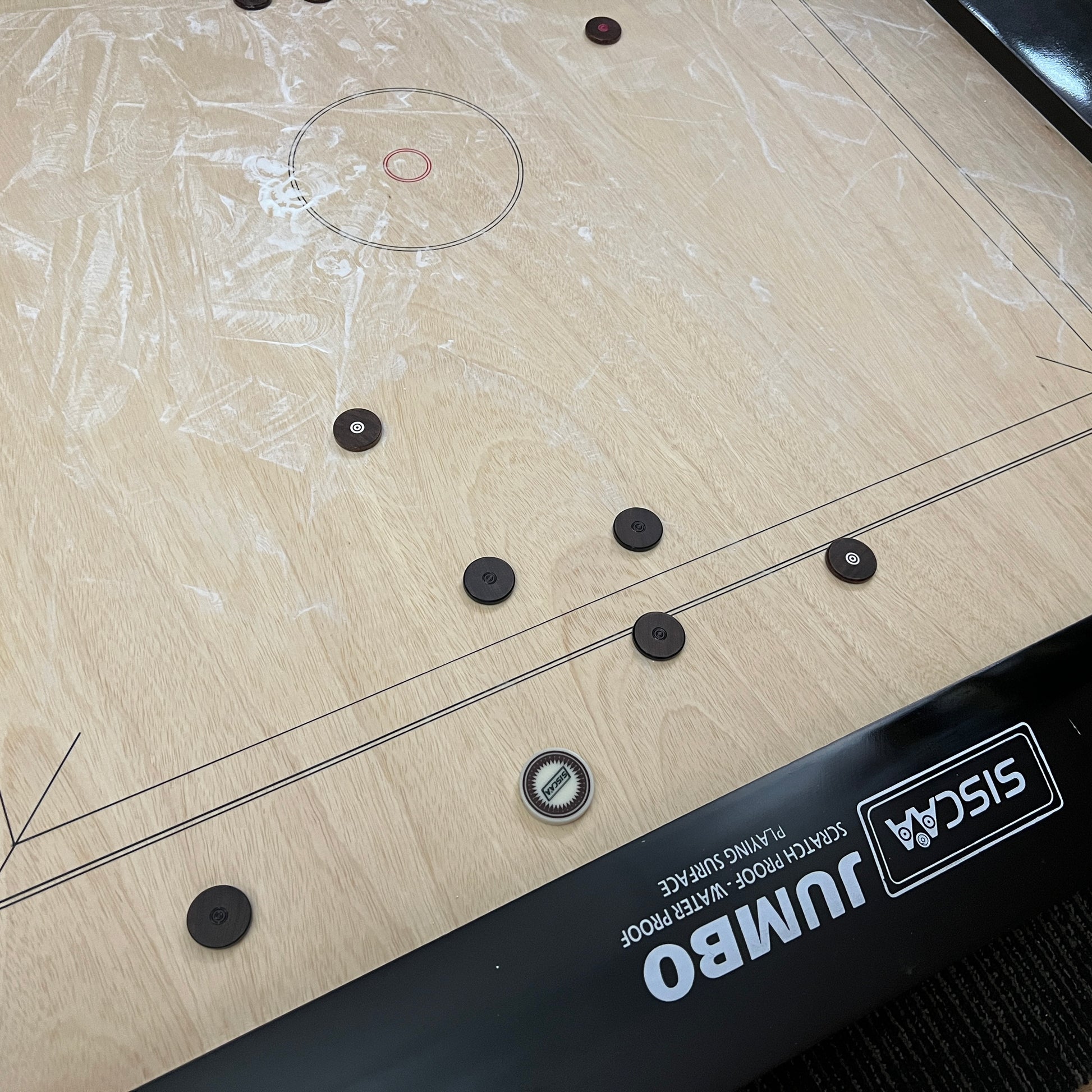 Black Ash 'Jumbo' high-end special edition carrom board by SISCAA, made of English Birchwood, 51x51 inches with a 41x41 inch playing area, 12mm sheet thickness, and 5-inch borders. Includes premium finish, fast rebound borders, heavy-duty back support, high-end coins, and 2 strikers.